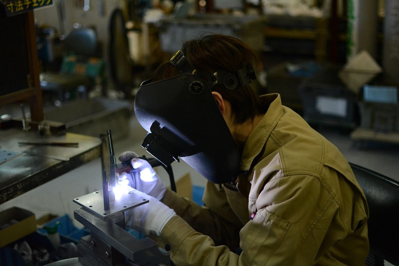Close-up of a TIG welding torch creating a precise, clean weld bead on steel
