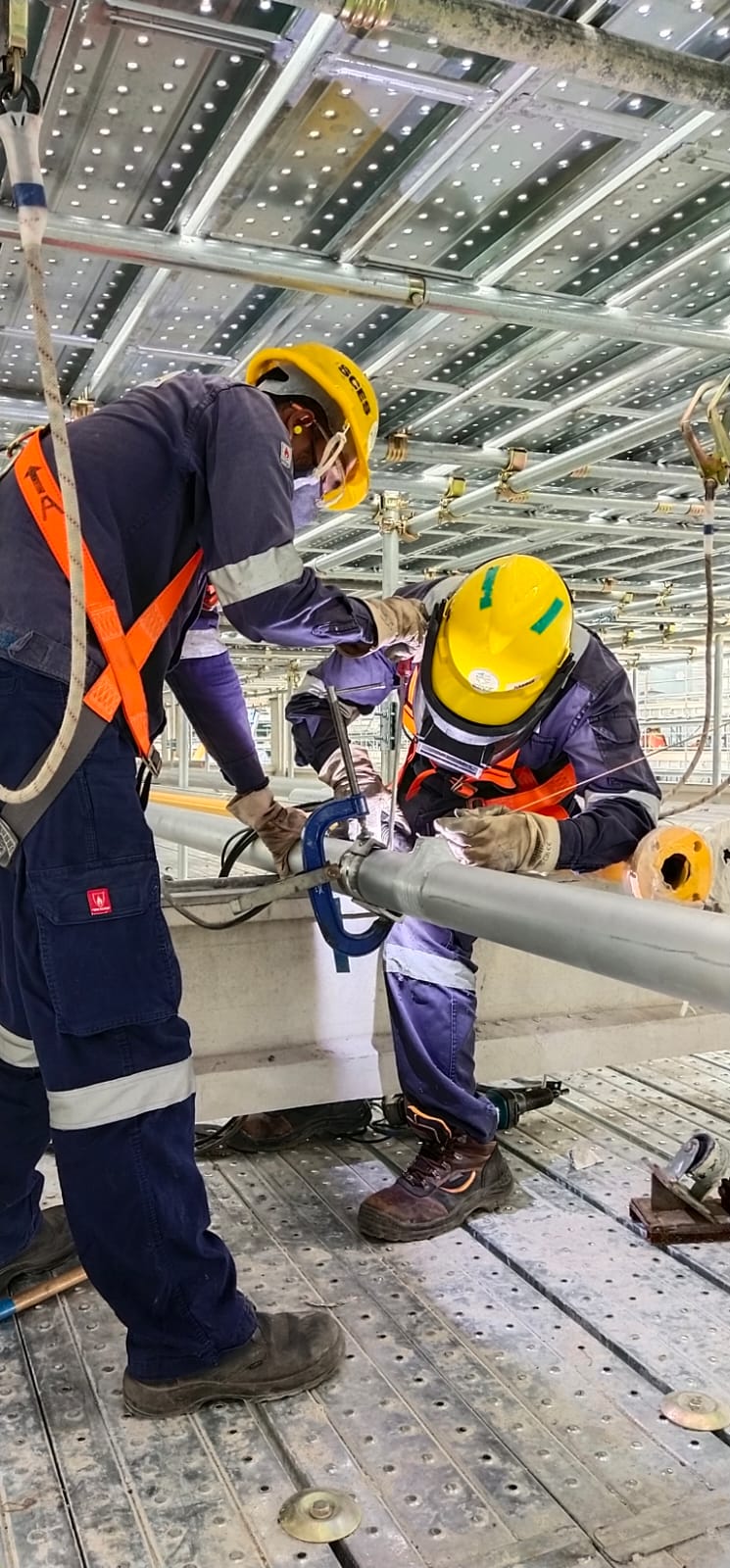 Piping installation and welding on scaffolding